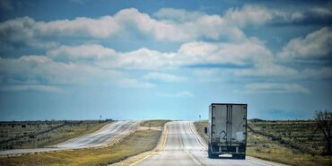 The back of a truck on a highway in Mexico. Bright blue sky and white truck.