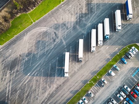 aerial view of Car_and_truck_parking_lot with white lorries