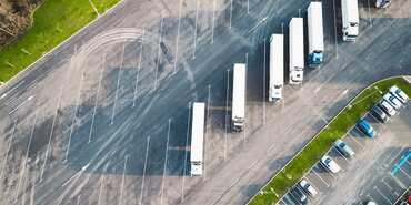 aerial view of Car_and_truck_parking_lot with white lorries