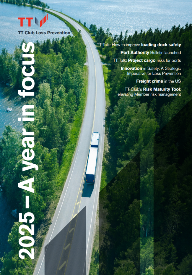 A lorry drives down a bridge with green trees and glistening water ahead. This image is the cover of a publication